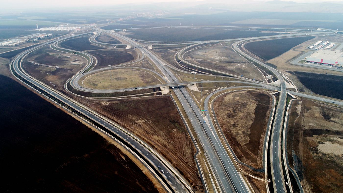 Photo: aerial view of a motorway junction showing a complex set-up of roads, bridges and underpasses