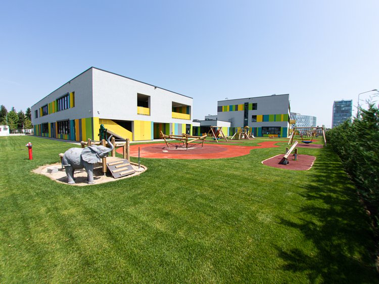 State-of-the-art campus at a new location. New children’s playground in front of a modern school building